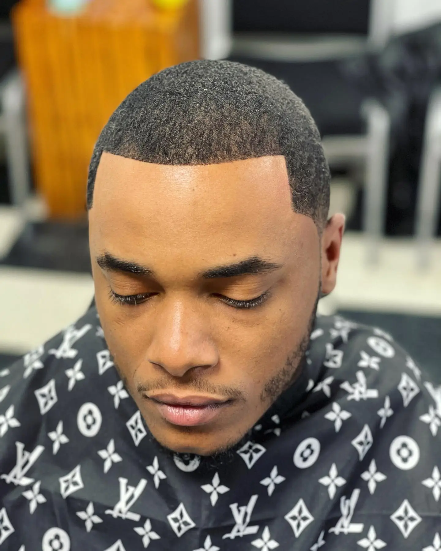 Low fade haircut with a sharp line-up